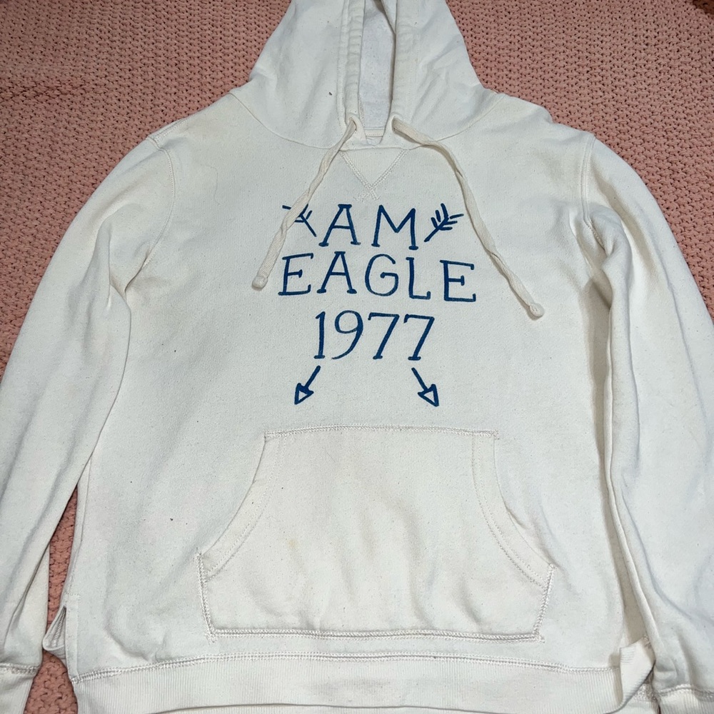 Off white, dark blue lettering “Am Eagle 1977”, hoodie
